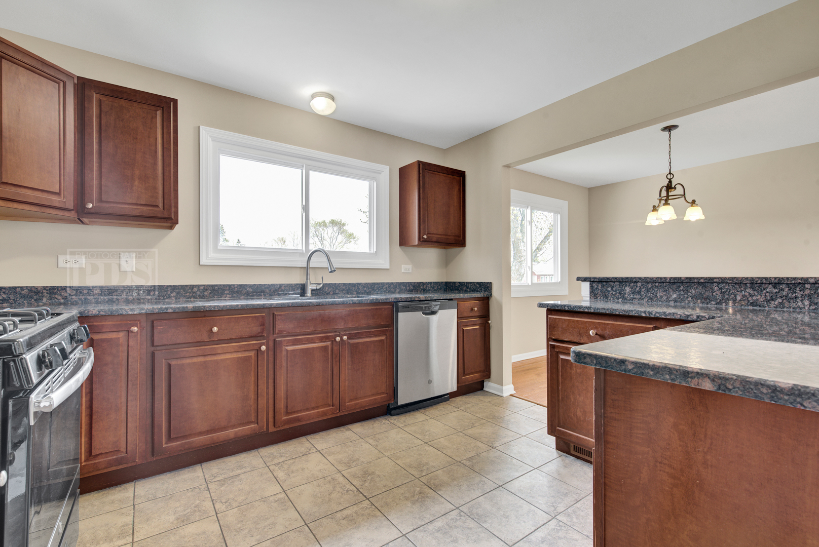 5762 Timberlane Road Matteson, IL 60443 - Photo 7 of 23 a kitchen with granite countertop a sink and a stove