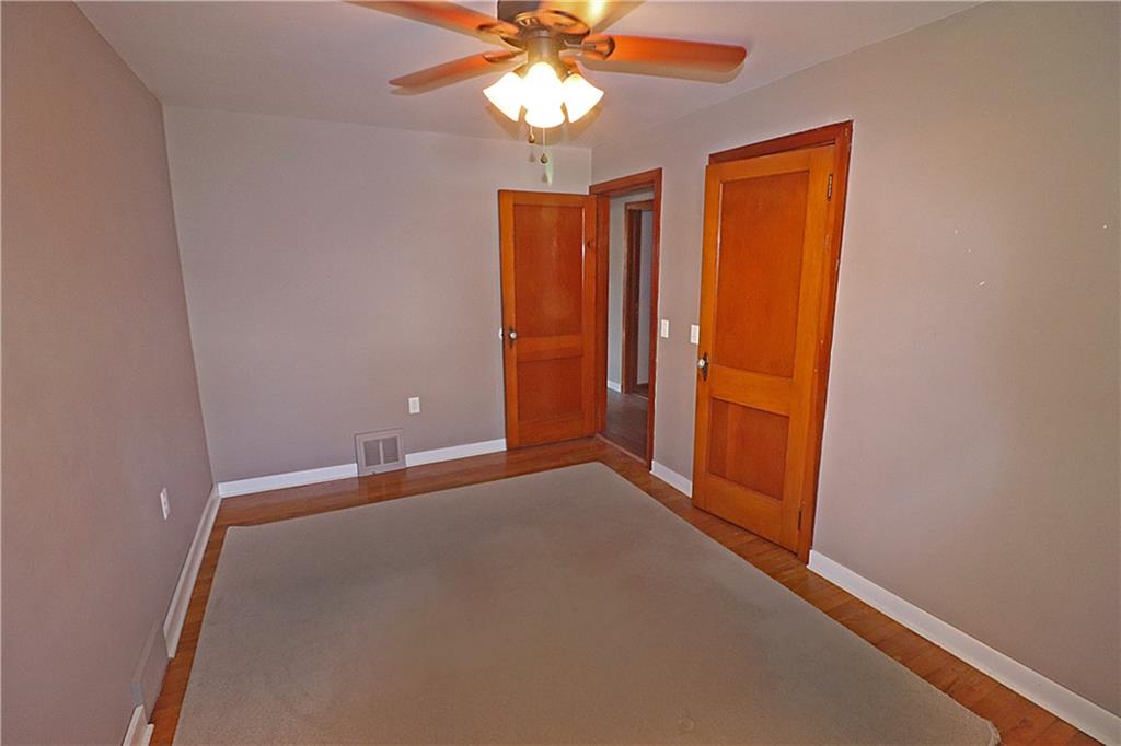 107 Penn Street Greensburg, PA 15601 - Photo 8 of 11 an empty room with closet and a chandelier fan