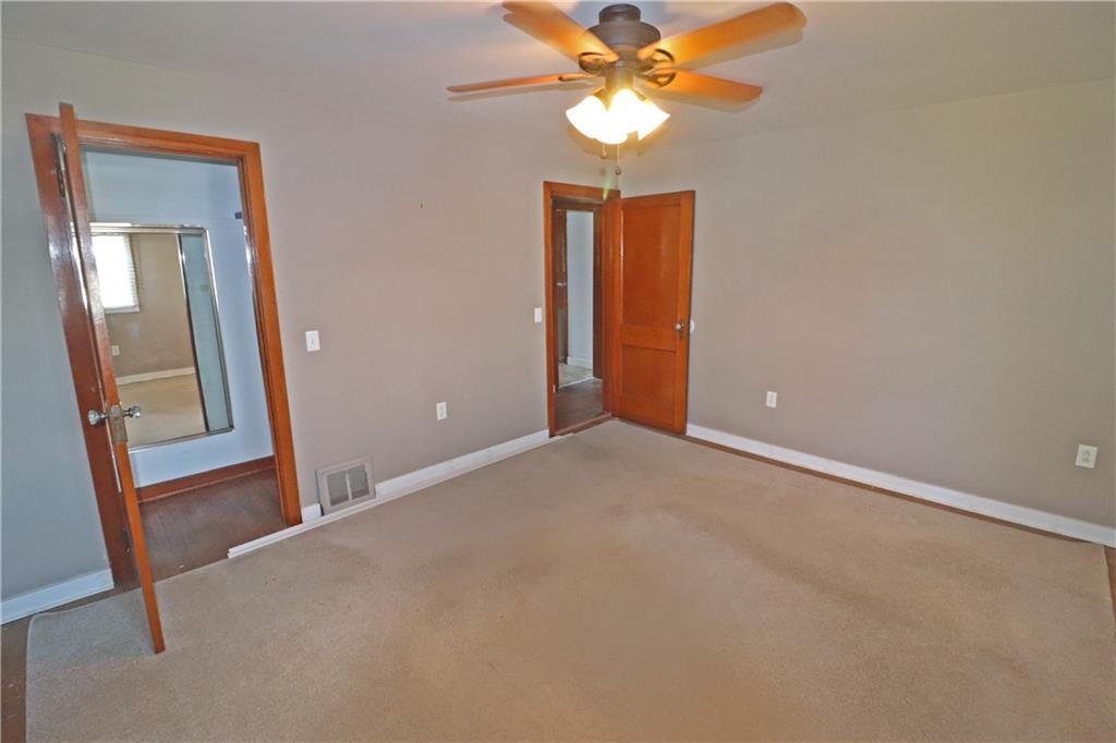 107 Penn Street Greensburg, PA 15601 - Photo 9 of 11 an empty room with a mirror and a fan
