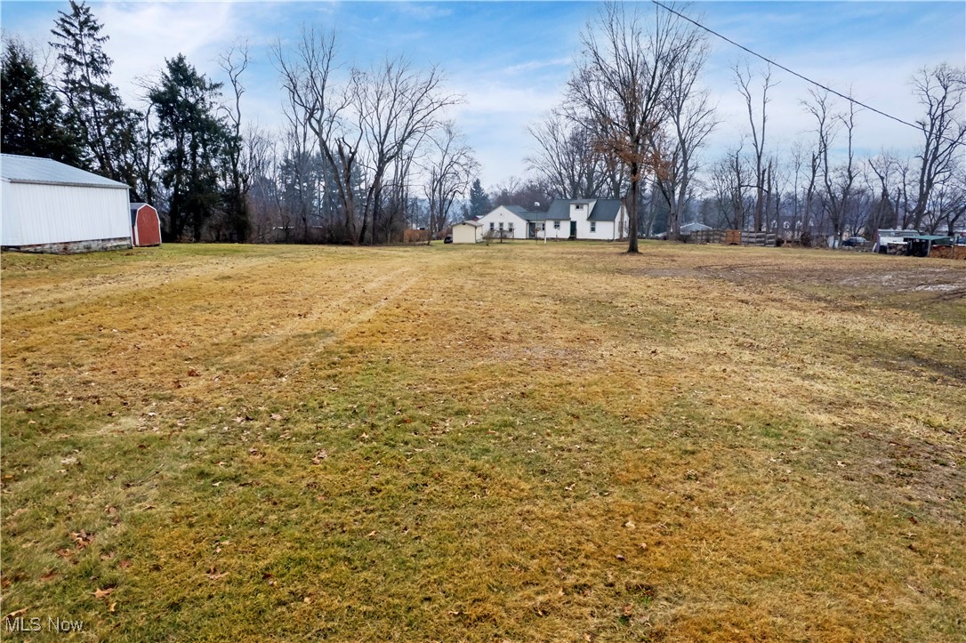 View of yard featuring a pole building and an outdoor structure