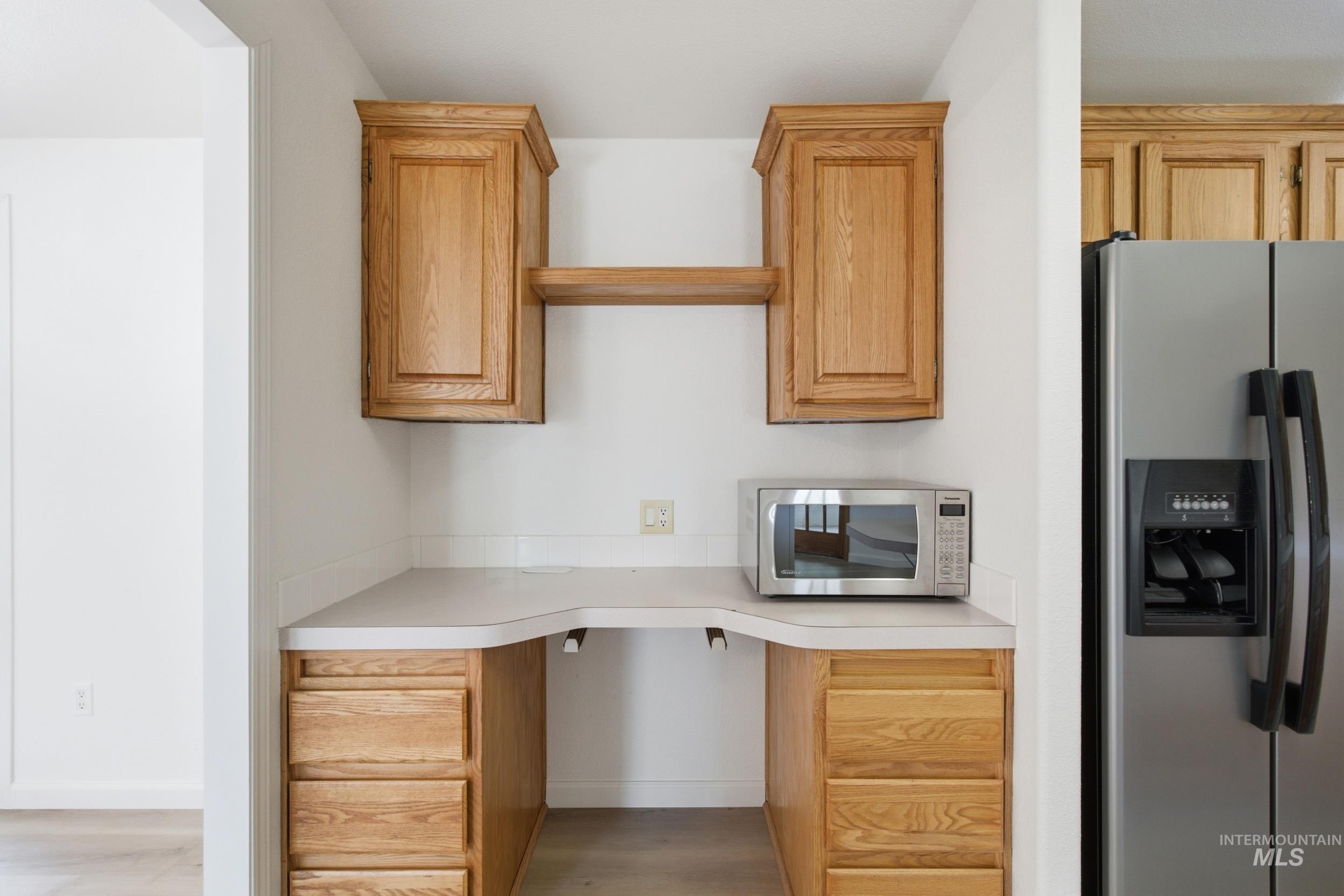 7422 Track Road Nampa, ID 83686 - Photo 11 of 50 Built-in desk area featuring light wood cabinetry with upper storage and an open shelf