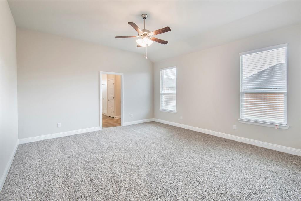 2301 Ruff Road Denton, TX 76205 - Photo 11 of 23 Spacious room featuring vaulted ceilings, light gray wall paint, and gray textured carpet flooring