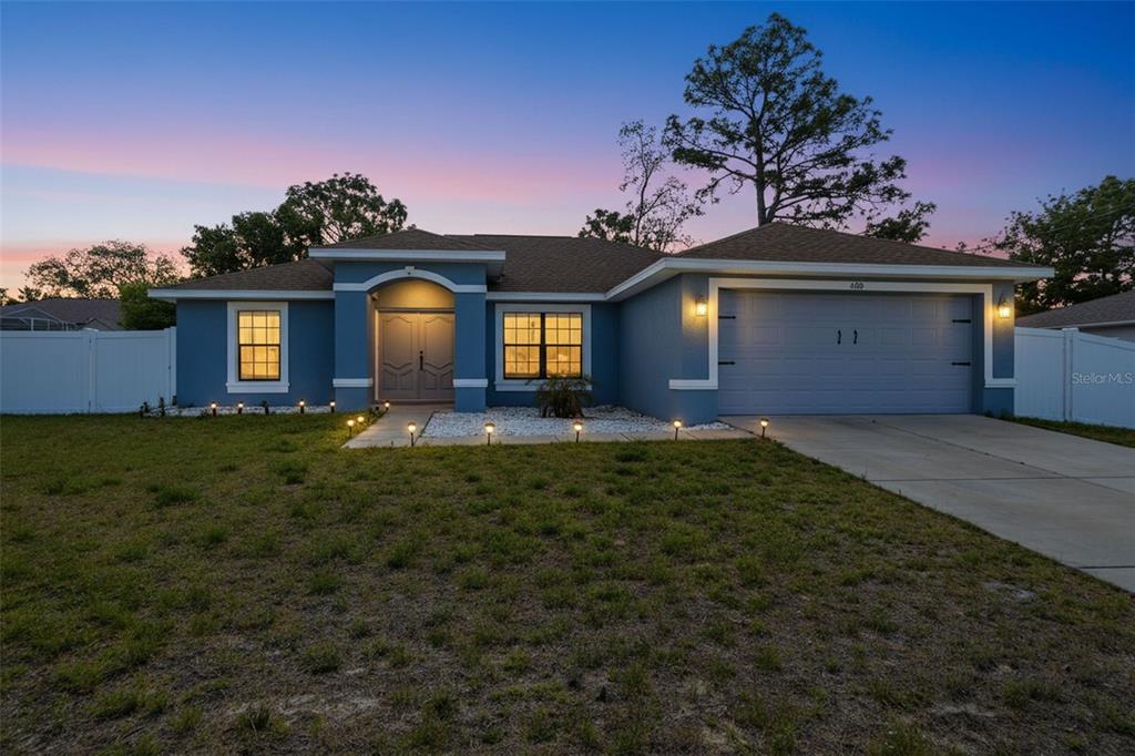 4128 Everett Avenue Spring Hill, FL 34609 - Photo 1 of 57 front view of a house with a yard