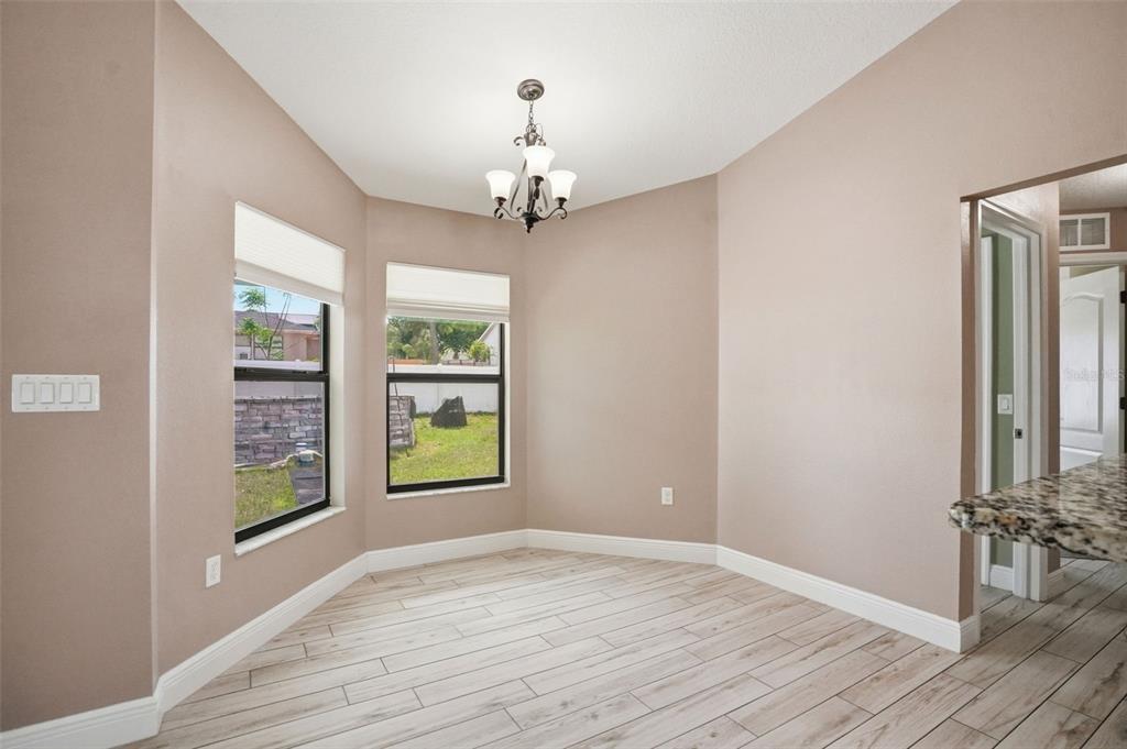 4128 Everett Avenue Spring Hill, FL 34609 - Photo 14 of 57 wooden floor in an empty room with a window