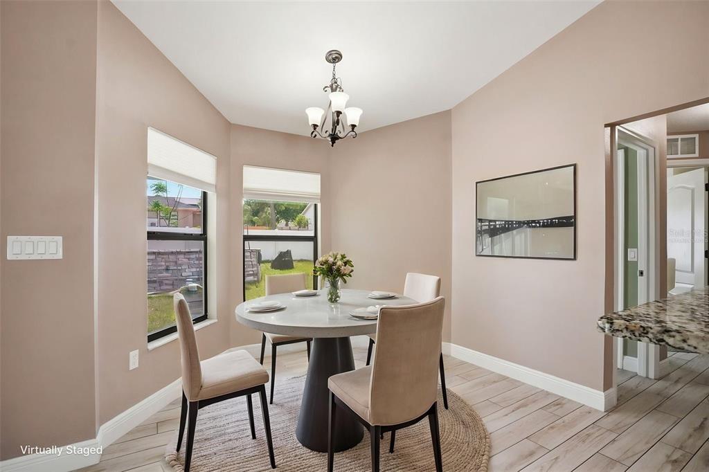 4128 Everett Avenue Spring Hill, FL 34609 - Photo 15 of 57 a view of a dining room with furniture window and wooden floor