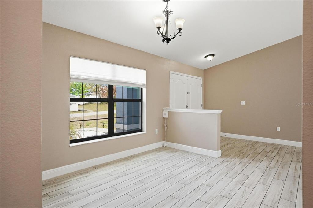 4128 Everett Avenue Spring Hill, FL 34609 - Photo 16 of 57 a view of an empty room with a window and wooden floor