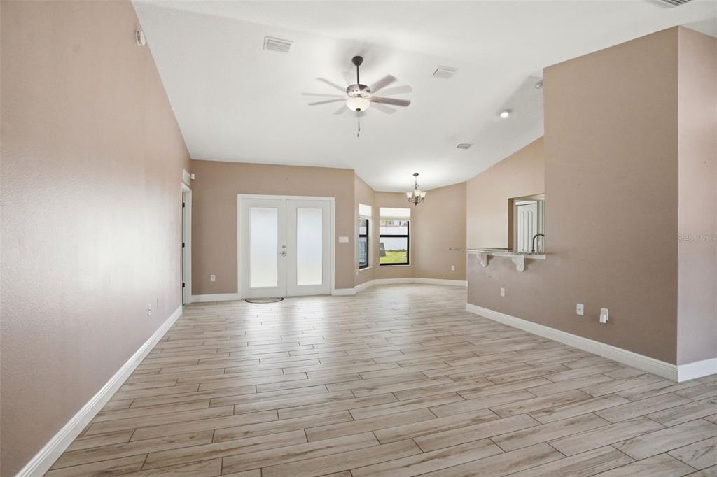4128 Everett Avenue Spring Hill, FL 34609 - Photo 19 of 57 wooden floor in an empty room with a window