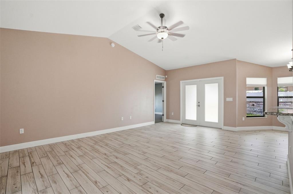 4128 Everett Avenue Spring Hill, FL 34609 - Photo 21 of 57 a view of an empty room with a window and wooden floor
