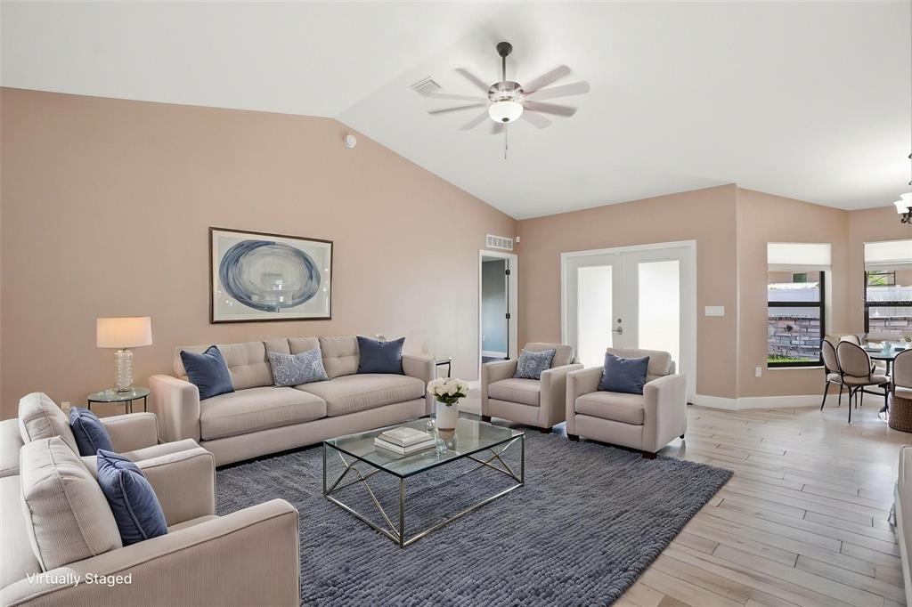 4128 Everett Avenue Spring Hill, FL 34609 - Photo 22 of 57 a living room with furniture and wooden floor