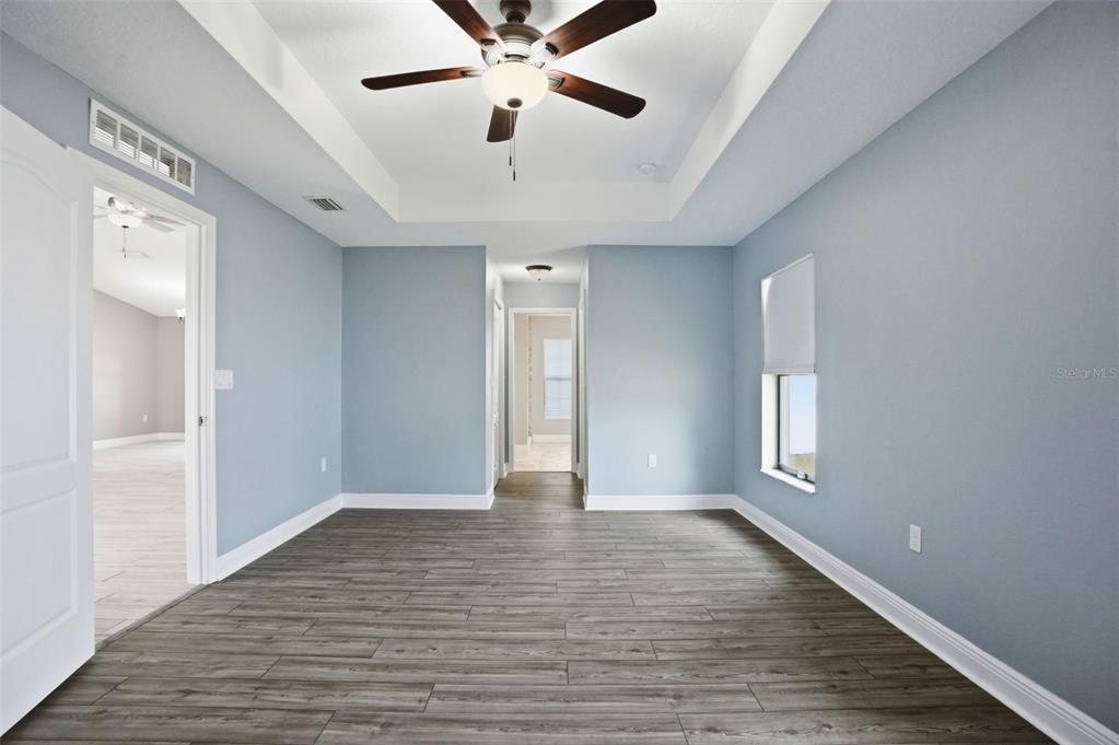 4128 Everett Avenue Spring Hill, FL 34609 - Photo 27 of 57 an empty room with wooden floor and windows