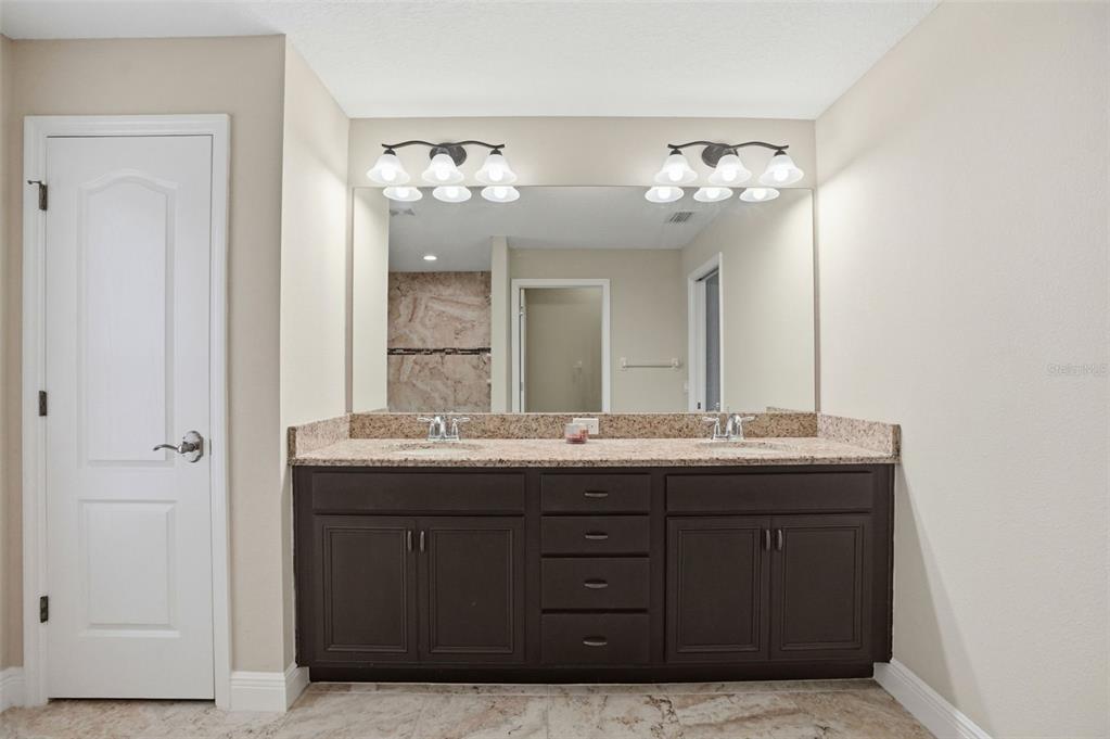 4128 Everett Avenue Spring Hill, FL 34609 - Photo 29 of 57 a bathroom with a sink double vanity and a mirror