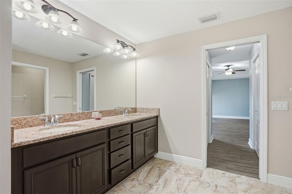 4128 Everett Avenue Spring Hill, FL 34609 - Photo 32 of 57 a bathroom with a double vanity sink and a mirror