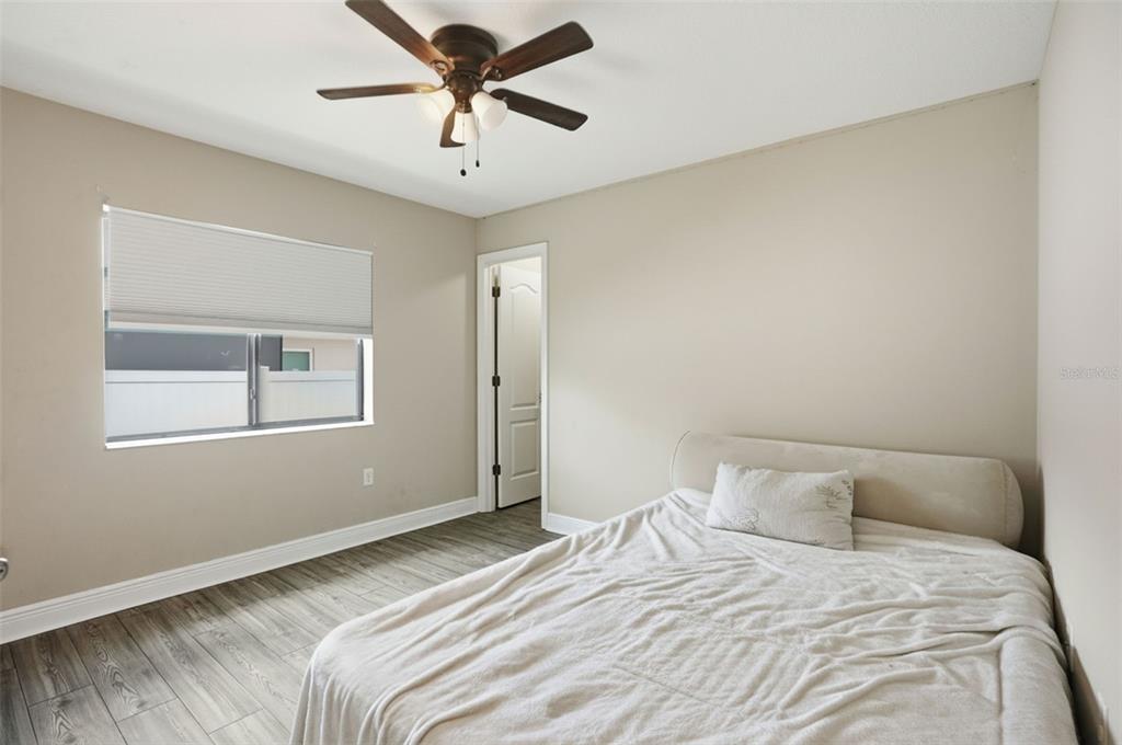 4128 Everett Avenue Spring Hill, FL 34609 - Photo 39 of 57 a bedroom with a large bed and a window