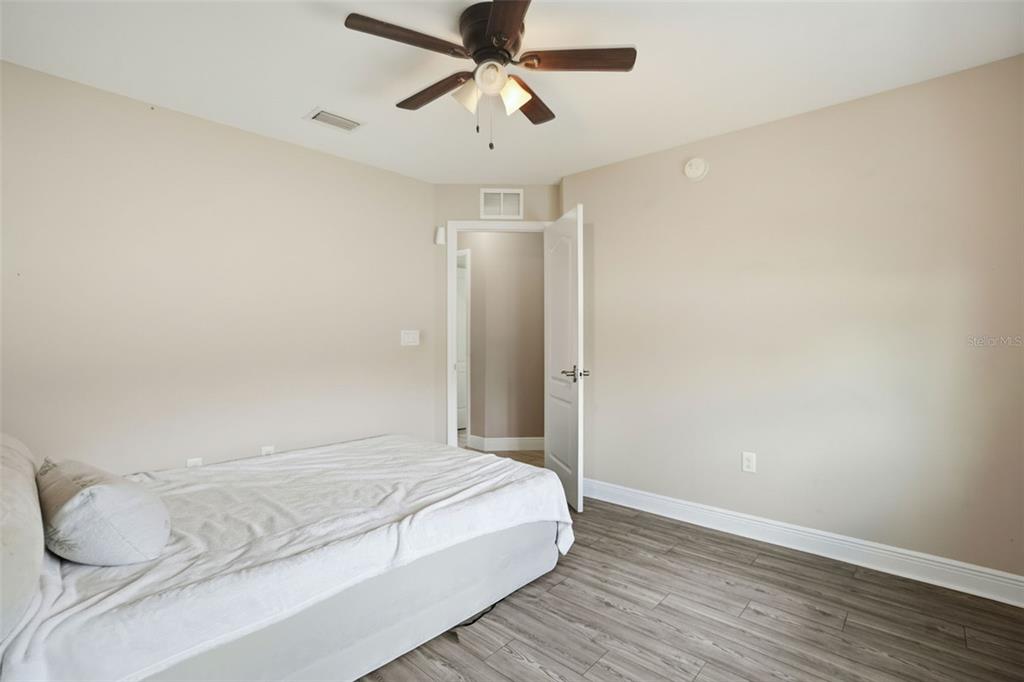 4128 Everett Avenue Spring Hill, FL 34609 - Photo 40 of 57 a bedroom with a bed and a ceiling fan