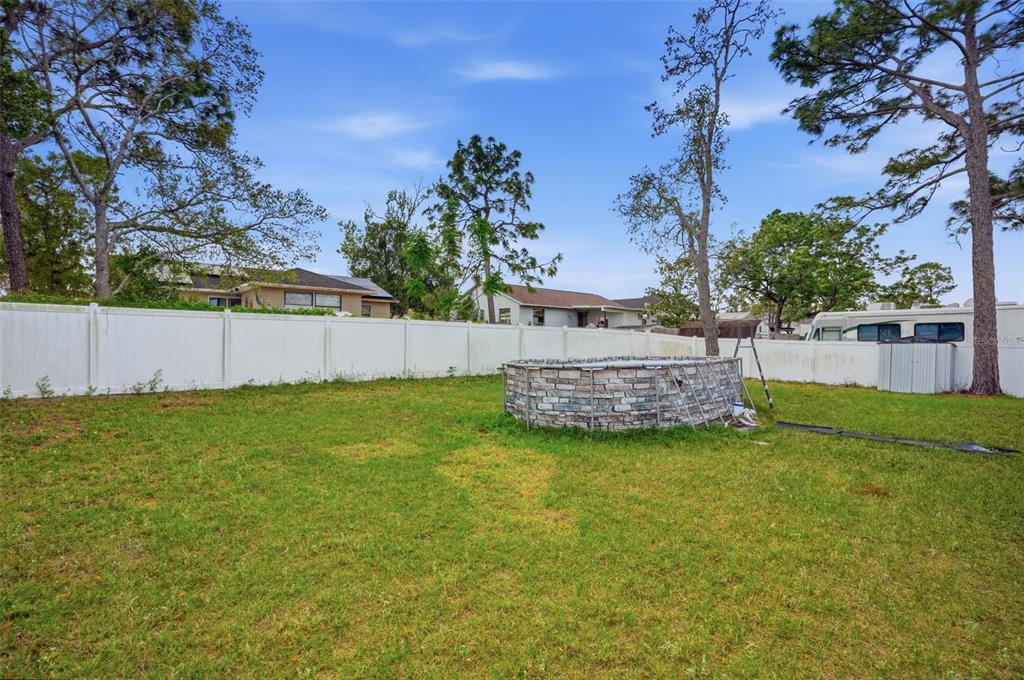 4128 Everett Avenue Spring Hill, FL 34609 - Photo 45 of 57 a view of a backyard with plants and a garden