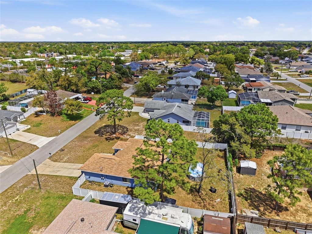 4128 Everett Avenue Spring Hill, FL 34609 - Photo 52 of 57 an aerial view of residential houses with outdoor space and trees