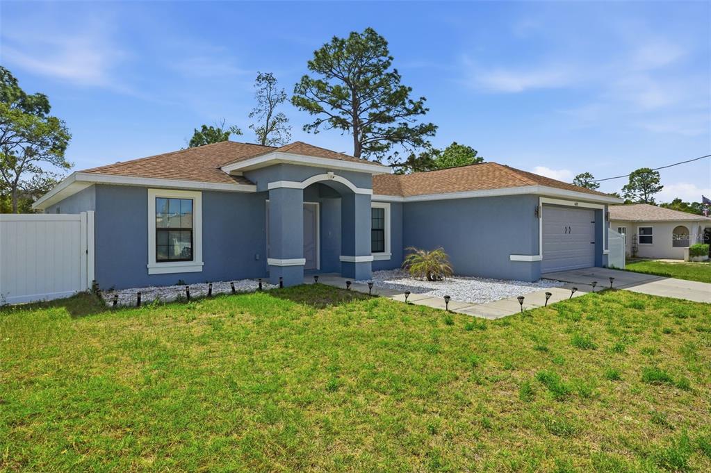 4128 Everett Avenue Spring Hill, FL 34609 - Photo 55 of 57 a front view of a house with garden