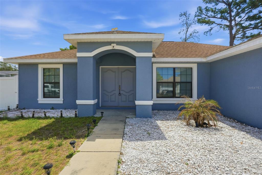 4128 Everett Avenue Spring Hill, FL 34609 - Photo 56 of 57 a front view of a house with garden