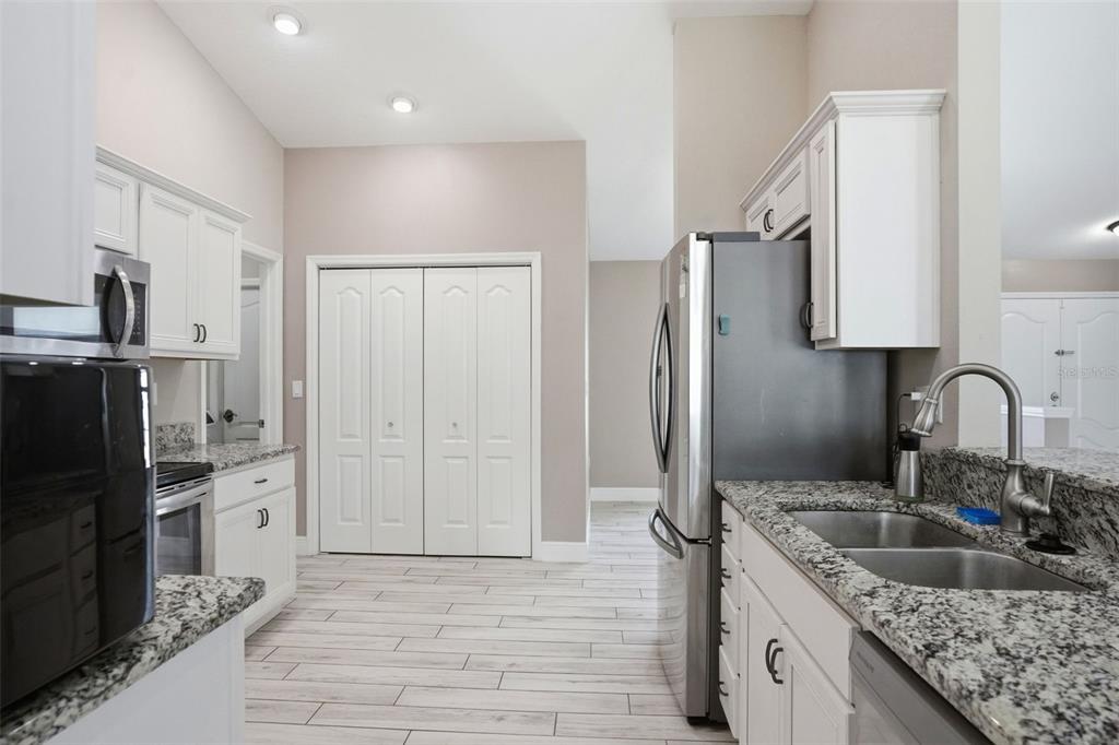 4128 Everett Avenue Spring Hill, FL 34609 - Photo 7 of 57 a kitchen with stainless steel appliances granite countertop a refrigerator and a sink