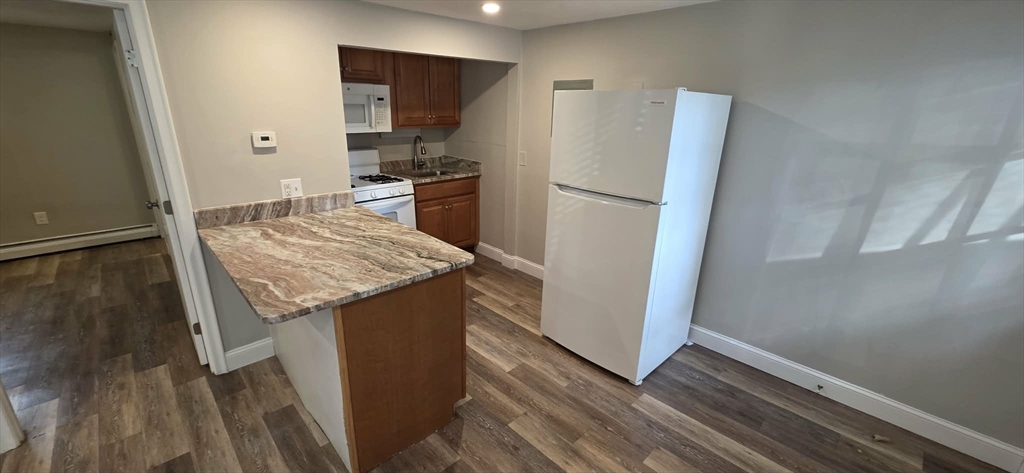 62 Cabot, Unit 2 Beverly, MA 01915 - Photo 1 of 5 a kitchen with granite countertop a refrigerator and a sink