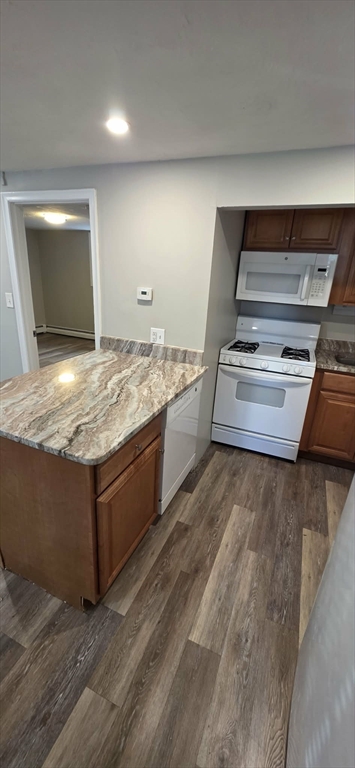 62 Cabot, Unit 2 Beverly, MA 01915 - Photo 2 of 5 a living room with granite countertop furniture and a flat screen tv