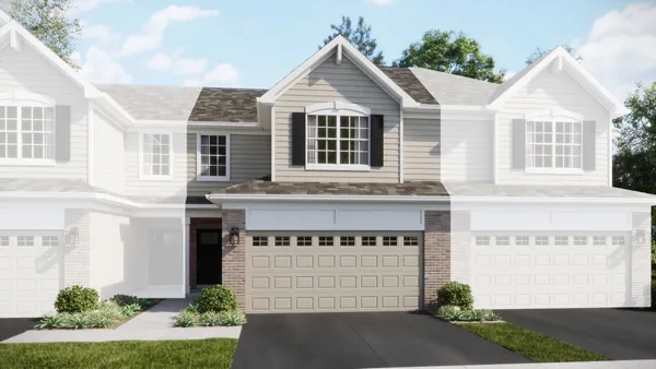 a front view of a house with a garden and garage