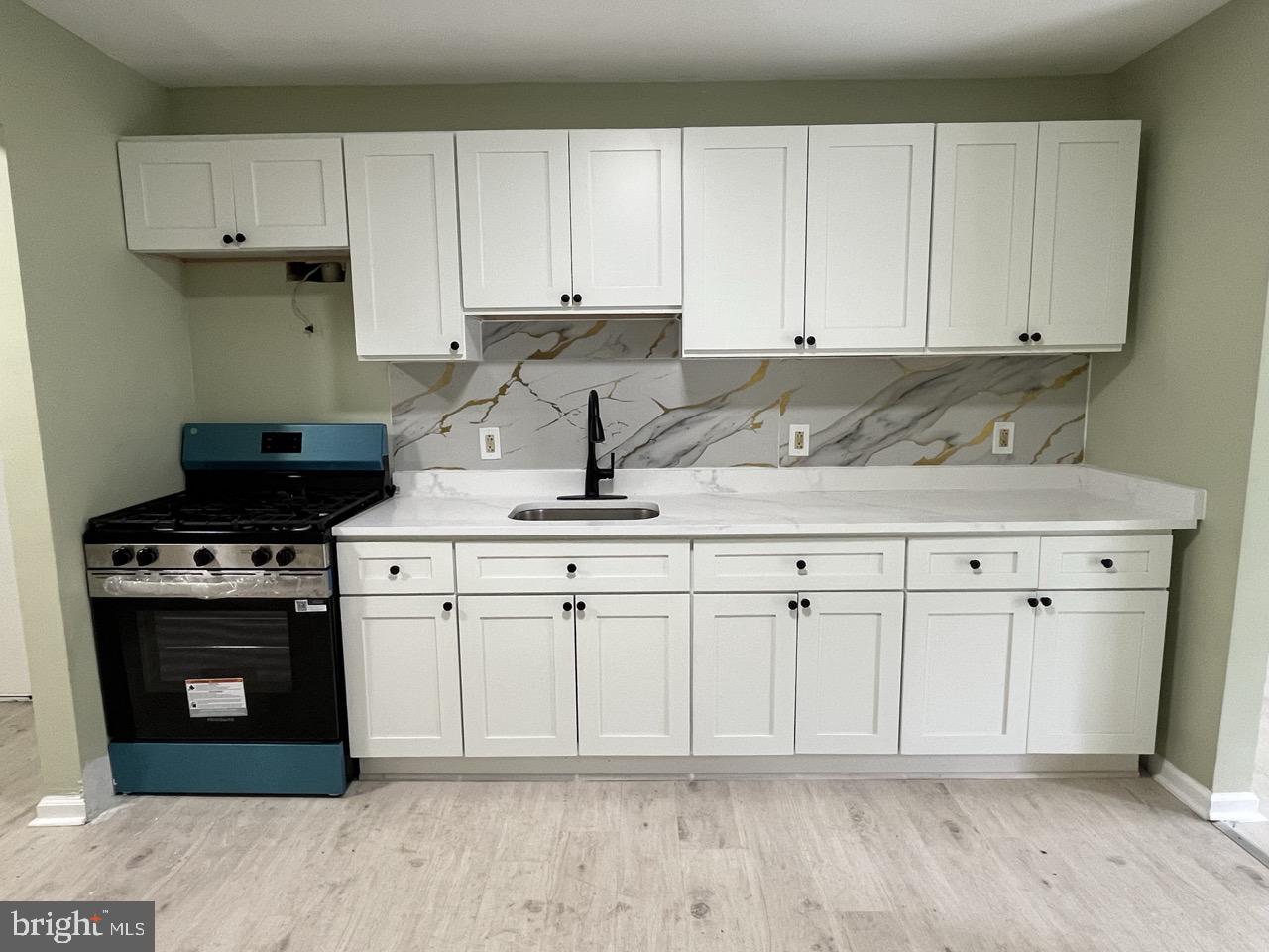 216 Kinsley Road Pemberton, NJ 08068 - Photo 2 of 19 a kitchen with white cabinets granite counter tops and a stove