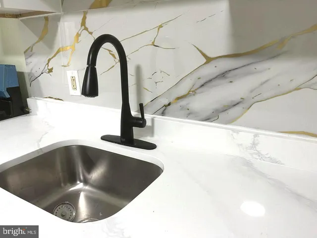 a kitchen with a sink and a stove