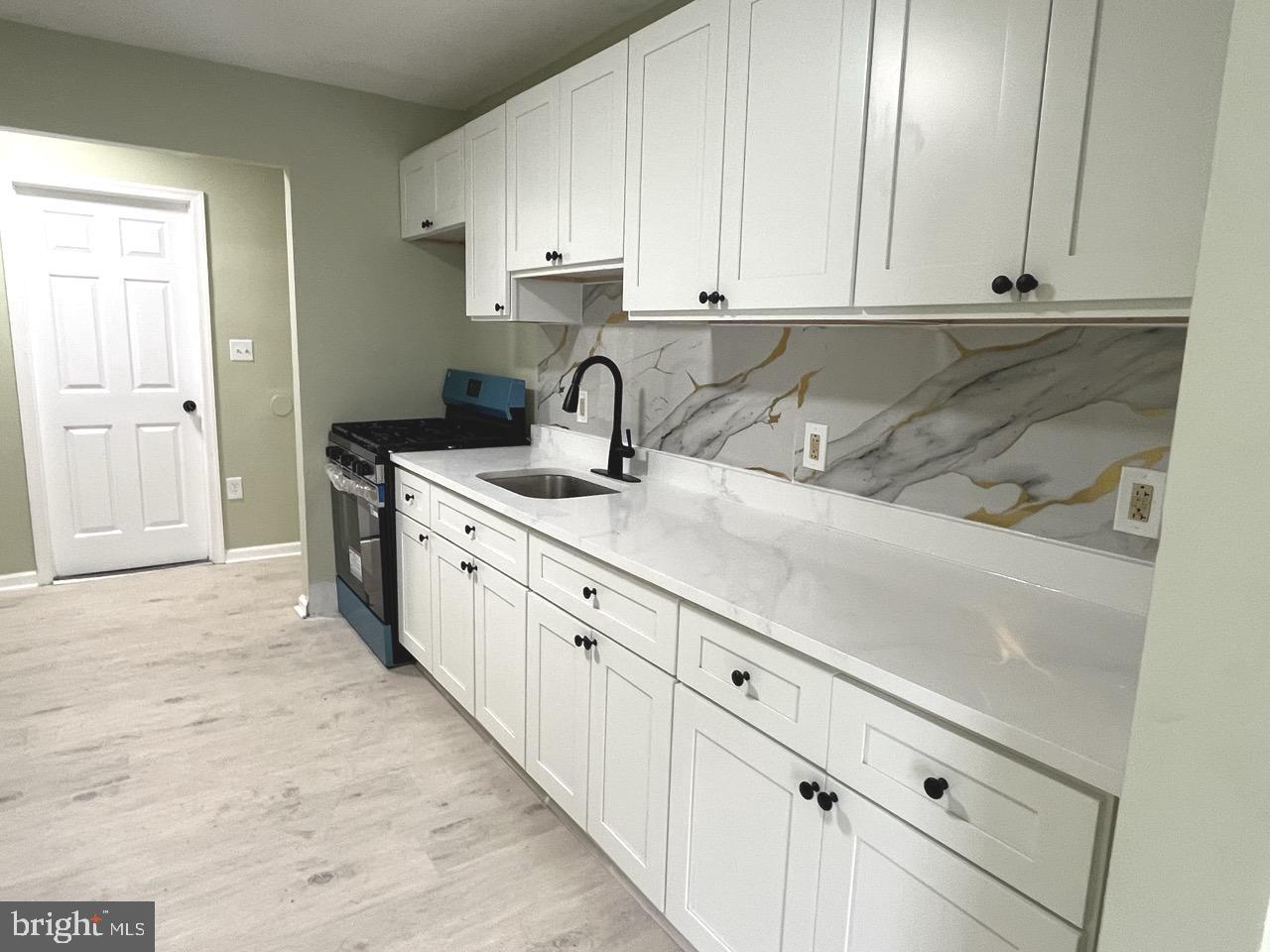 216 Kinsley Road Pemberton, NJ 08068 - Photo 6 of 19 a kitchen with stainless steel appliances granite countertop a sink and dishwasher with white cabinets