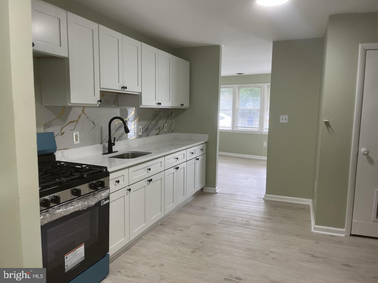 216 Kinsley Road Pemberton, NJ 08068 - Photo 7 of 19 a kitchen with kitchen island granite countertop a sink stove and cabinets