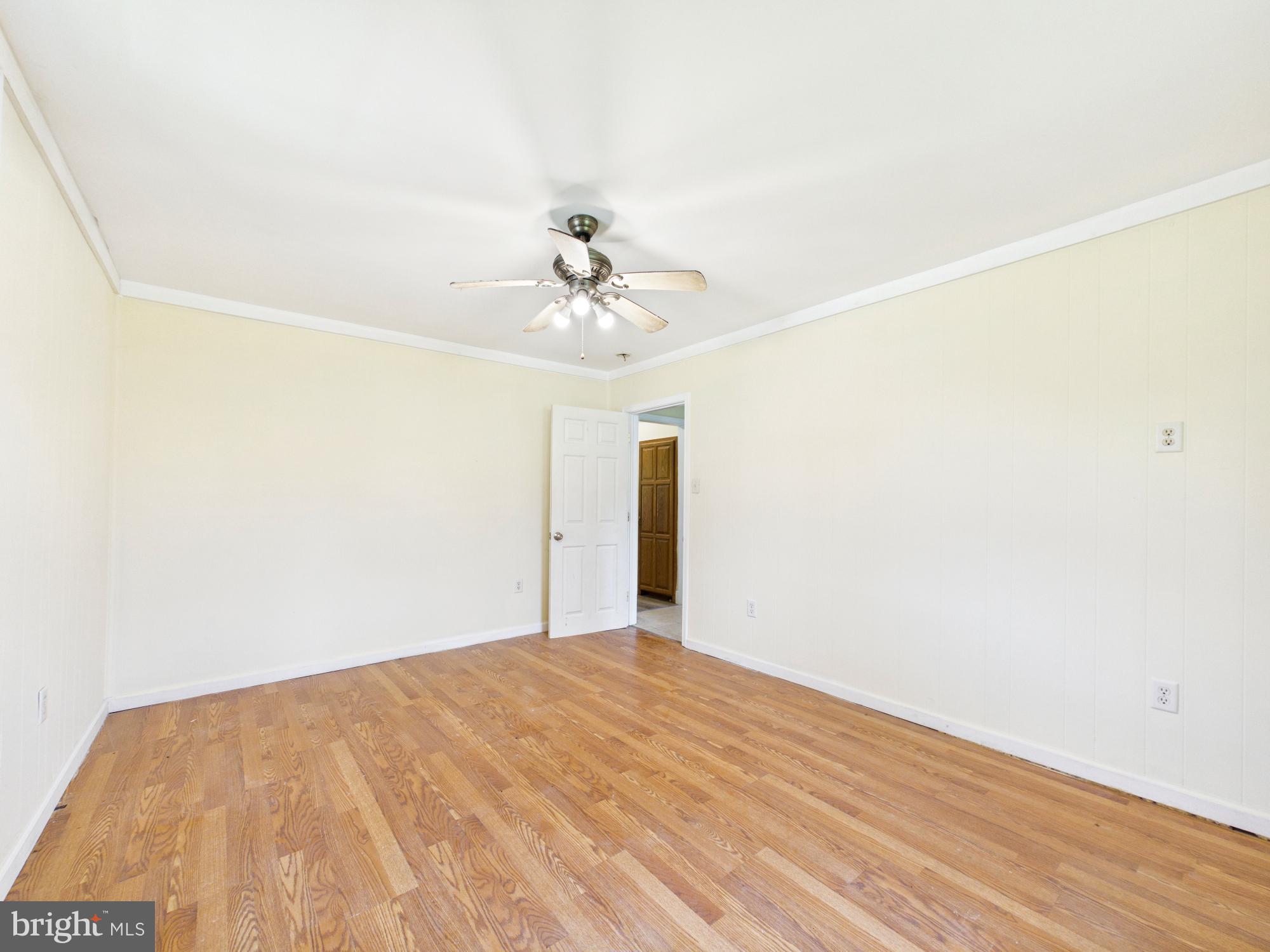 324 Jebb Road Camden Wyoming, DE 19934 - Photo 11 of 49 a view of a big room with wooden floor and chandelier fan