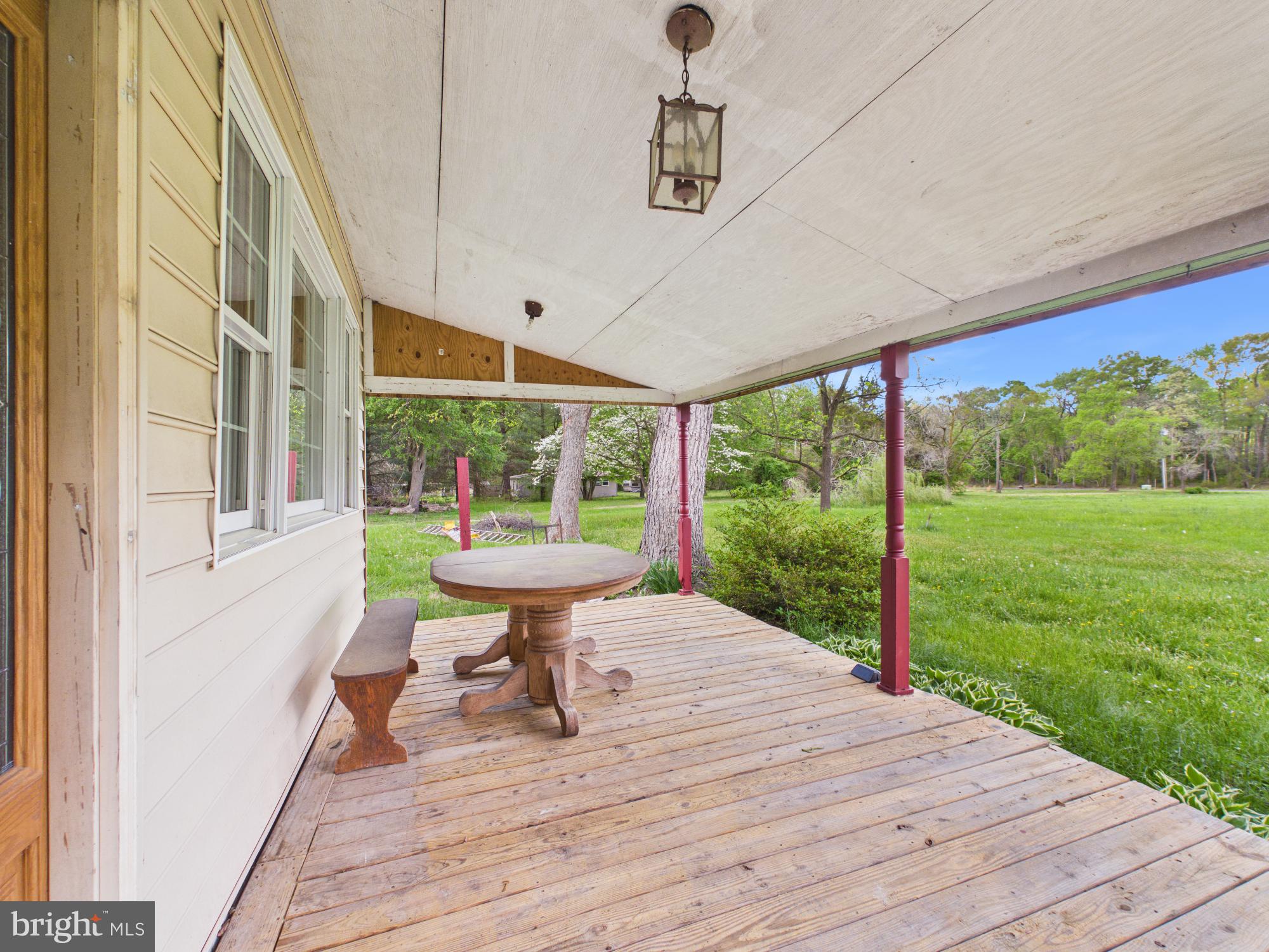324 Jebb Road Camden Wyoming, DE 19934 - Photo 28 of 49 a view of a patio with a table chairs and floor to ceiling window