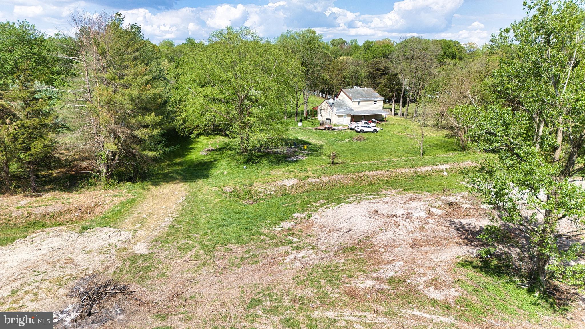 324 Jebb Road Camden Wyoming, DE 19934 - Photo 43 of 49 a white house sitting in middle of the green field