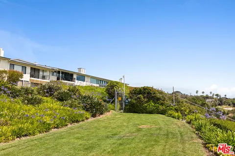 a view of houses with yard and mountain view