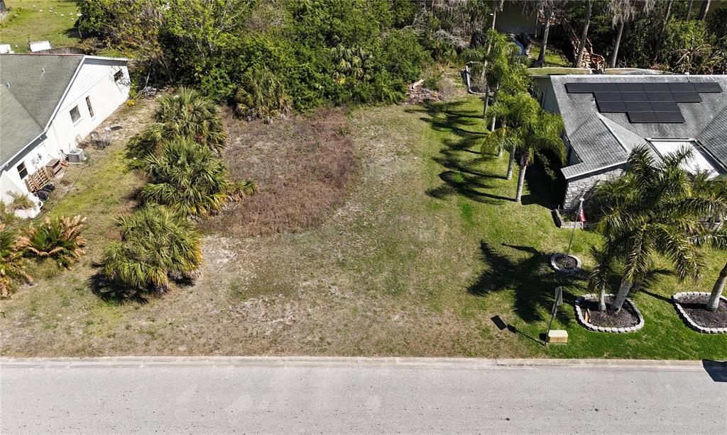 Whitby Road Hudson, FL 34667 - Photo 28 of 28 a backyard of a house with a yard and outdoor seating