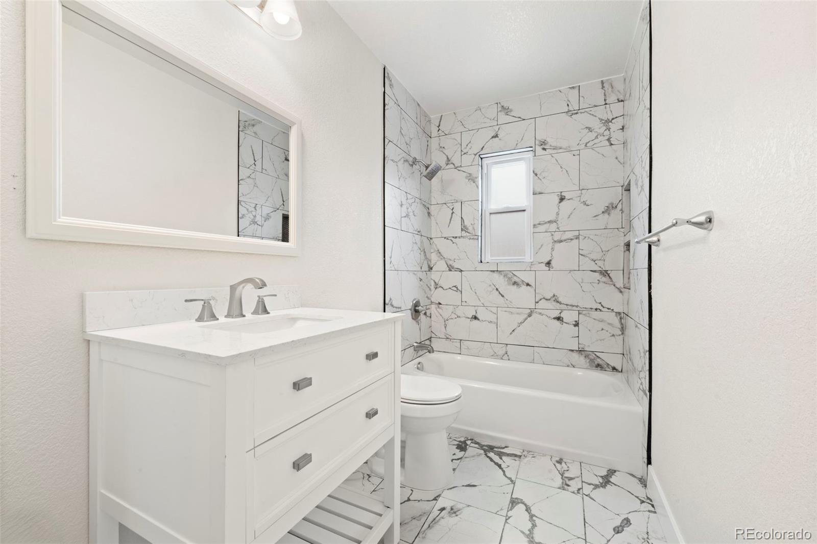 1216 Ursula Street Aurora, CO 80011 - Photo 14 of 30 a bathroom with a sink toilet a shower and bathtub