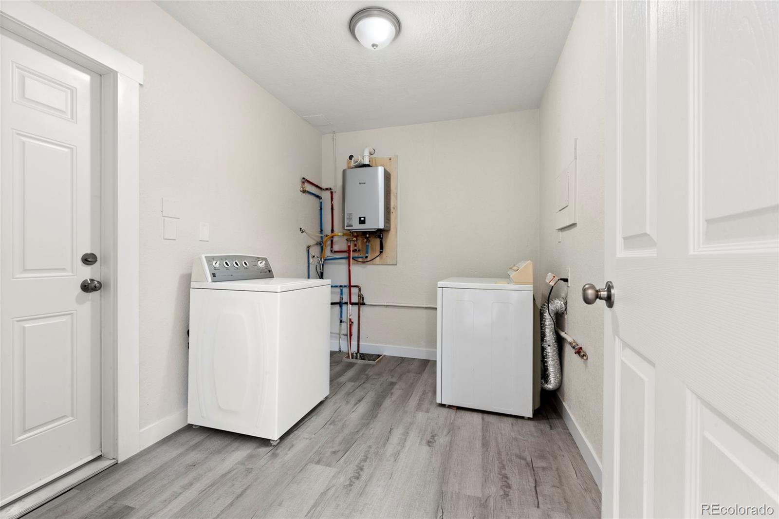 1216 Ursula Street Aurora, CO 80011 - Photo 19 of 30 a utility room with dryer and washer