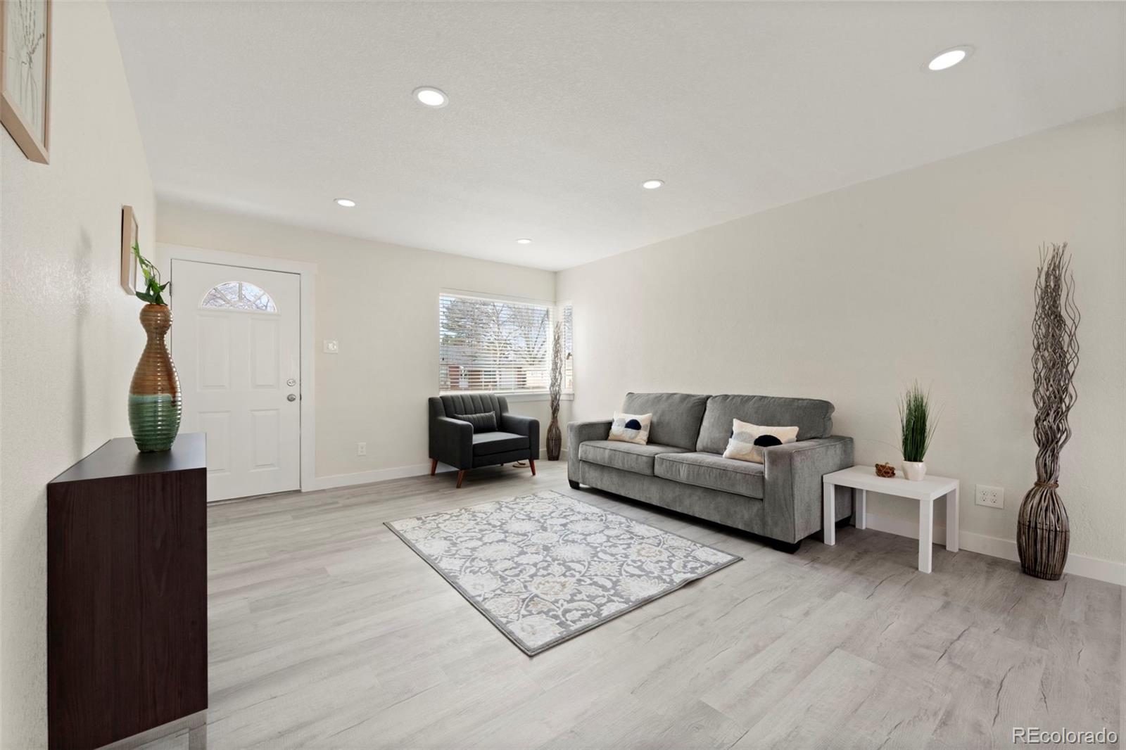 1216 Ursula Street Aurora, CO 80011 - Photo 9 of 30 a living room with furniture and wooden floor