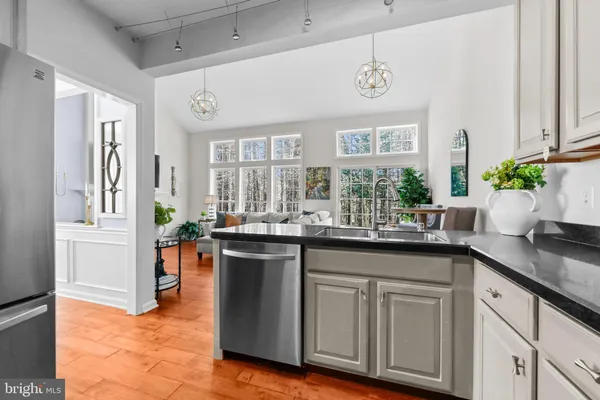 a kitchen with stainless steel appliances granite countertop a sink and a cabinets