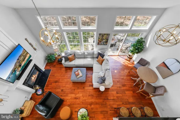 a living room with furniture and a floor to ceiling window