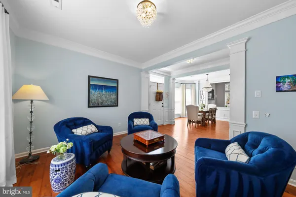 a living room with furniture and a lamp