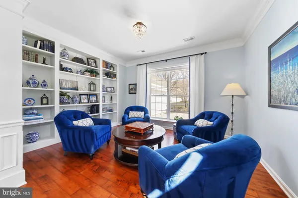 a living room with furniture and a book shelf