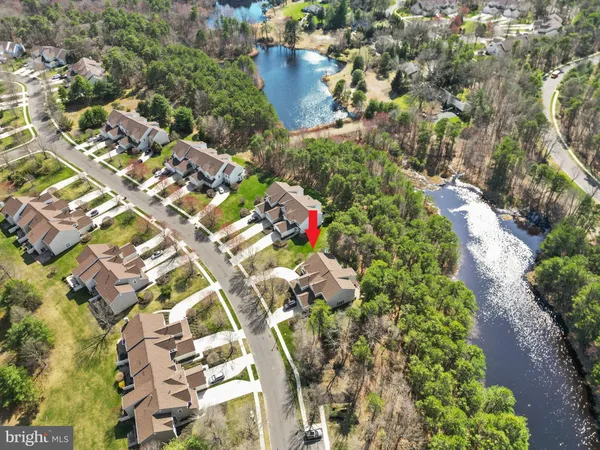 an aerial view of a house with a yard and garden