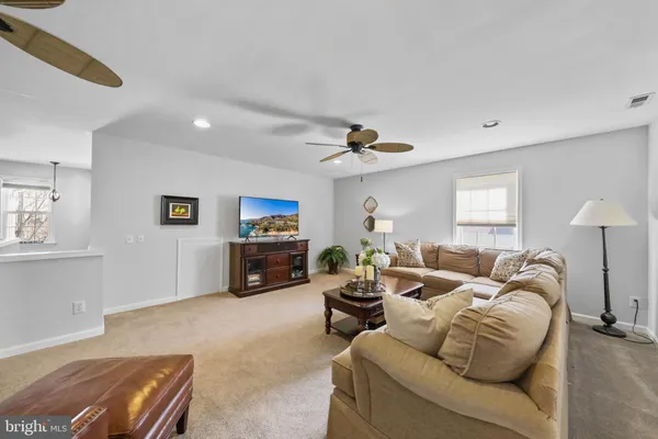 a living room with furniture a window and a flat screen tv