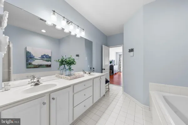 a spacious bathroom with a double vanity sink mirror and double