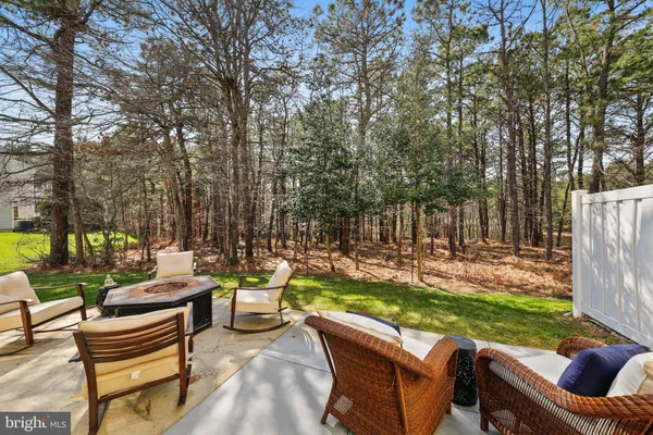 a view of a patio with couches chairs and a fire pit