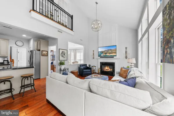 a living room with furniture a fireplace and a large window