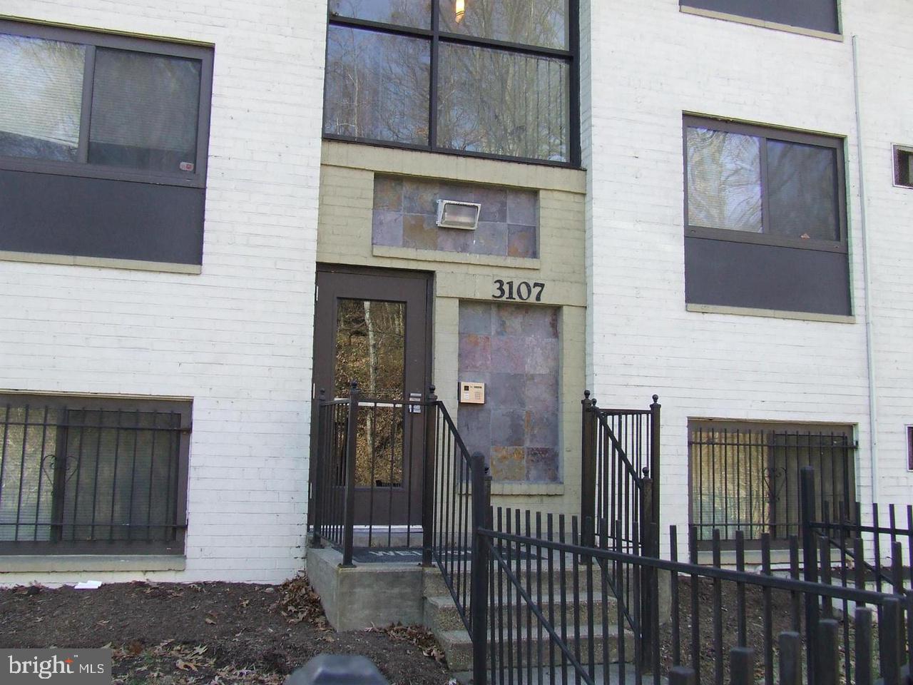a view of a brick house with many windows
