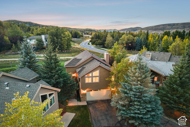 7396 Brook Hollow Loop Road Park City, UT 84098 - Photo 47 of 60 Exterior featuring multi-pitched rooflines, a prominent chimney, and a multi-pane window design
