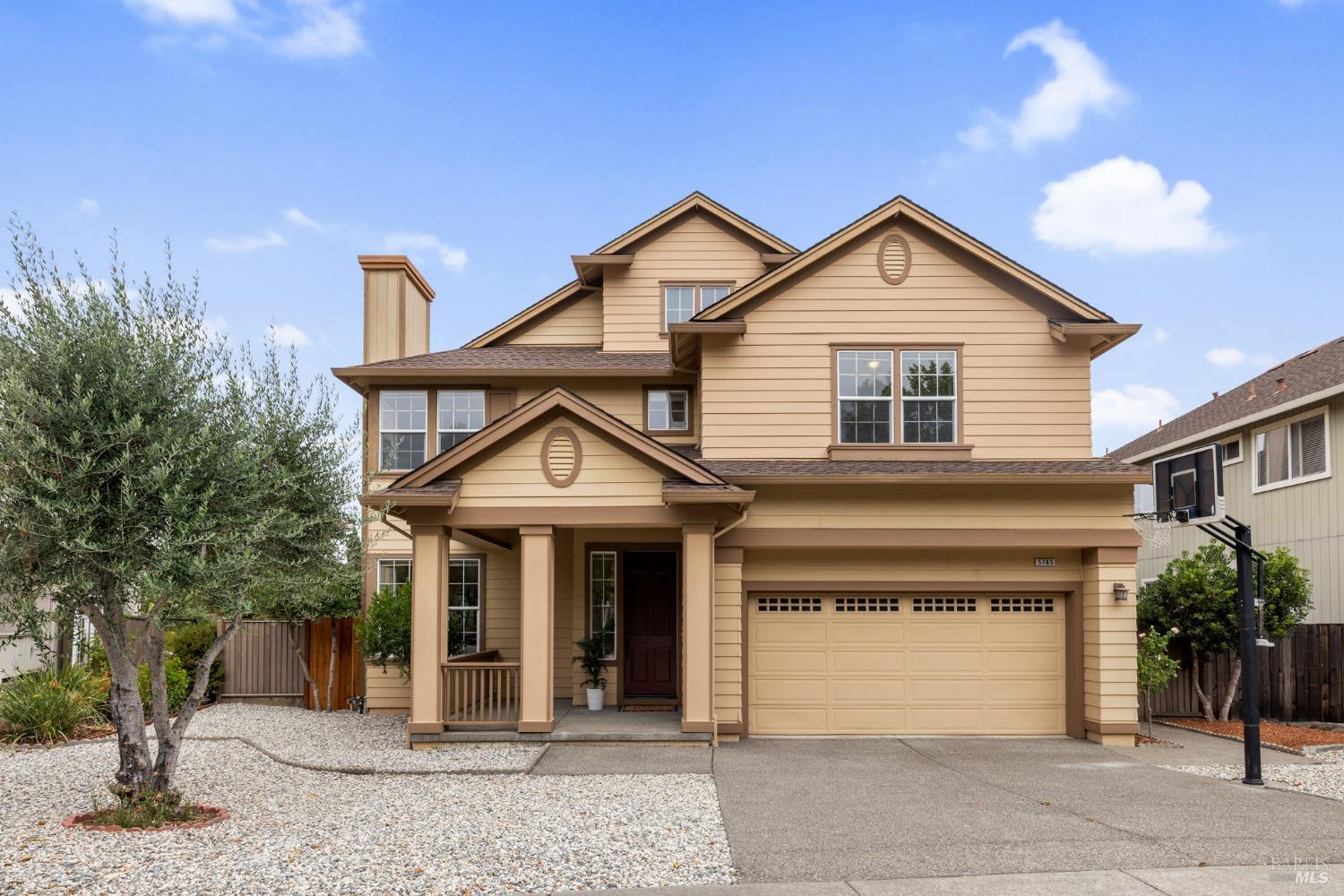 a view of a white house with large windows and palm trees